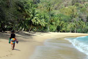 A beach goer takes a quite stroll along Englishman's Bay, Tobago
