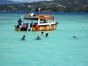 Visitors wade in the clear waters of Nylon Pool